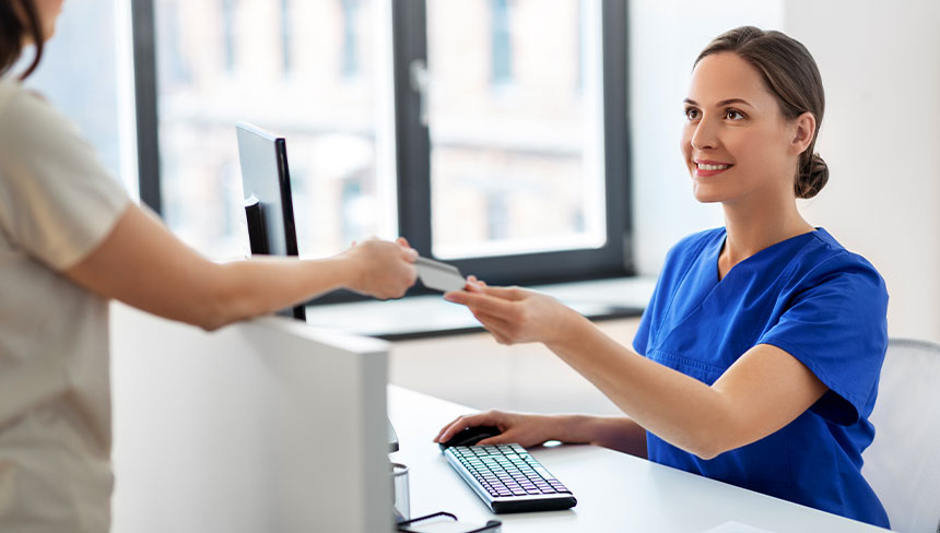 parent making a payment with the receptionist at Smith Family Chiropractic Wellness Center in Campbell, CA